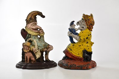 Lot 1563 - Two painted cast iron door stops modelled as...
