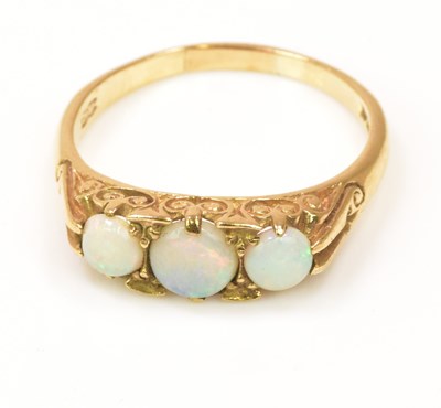Lot 1180 - A 9ct yellow gold three stone opal ring with...