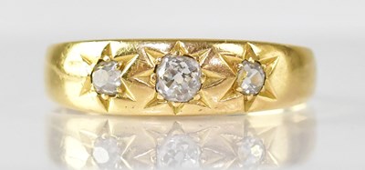 Lot 1064 - An 18ct yellow gold ring star set with three...