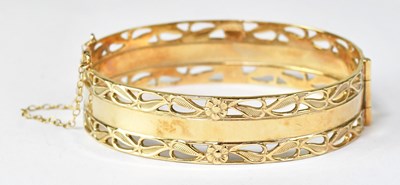 Lot 1154 - A 9ct gold hinged bracelet with central plain...