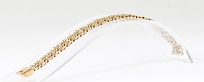 Lot 1144 - A 9ct gold bracelet with two rows of open...