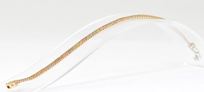 Lot 1147 - A 9ct three-colour gold semi-rigid bracelet...