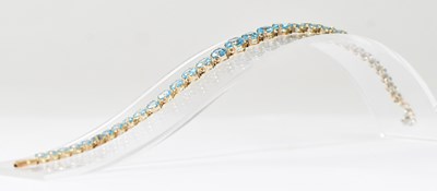 Lot 1149 - A 9ct gold topaz set line bracelet with box...