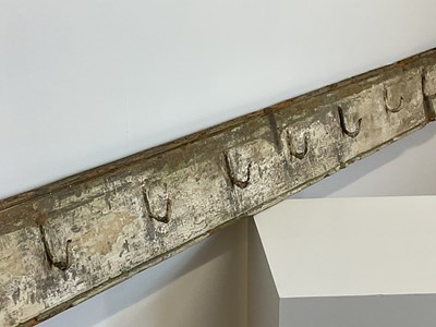 Lot 459 - Twelve forged metal meat hooks mounted on a...