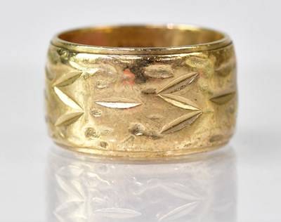 Lot 1090 - A 9ct gold wide band ring with textured...