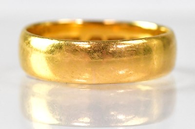 Lot 1058 - A 22ct gold wedding band, size P, approx. 5.4g.