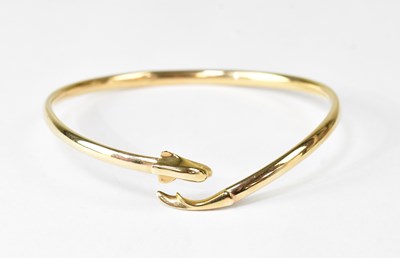 Lot 1155 - A 9ct gold hollow flexible bangle with dolphin...