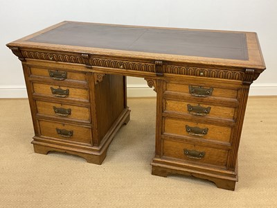 Lot 496 - A 19th century oak pedestal desk with a brown...