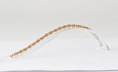 Lot 1145 - A 9ct gold textured link bracelet, with ring...