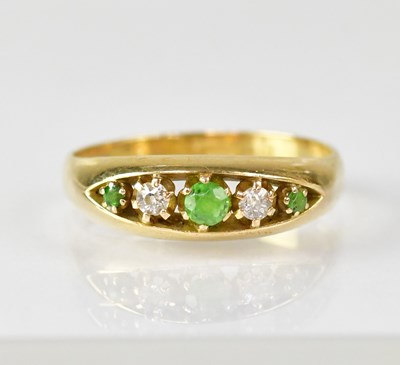Lot 1082 - An 18ct gold diamond and green stone set ring,...