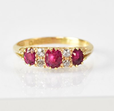 Lot 1081 - An 18ct ruby and diamond set ring, size P,...