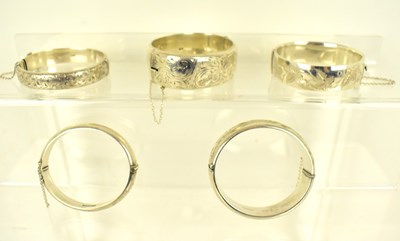 Lot 1161 - Five hallmarked silver hinged bracelets with...