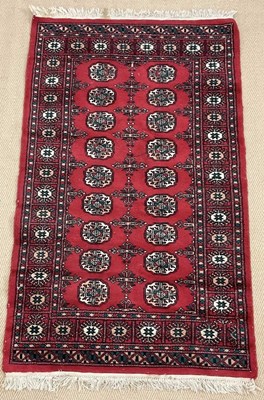 Lot 455 - A Persian rug, a deep red colour with double...