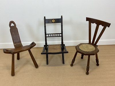 Lot 551 - Three chairs comprising an oak birthing chair,...
