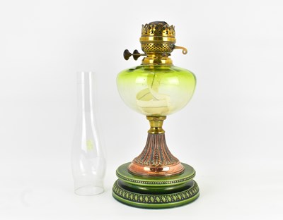 Lot 97 - A 19th century oil lamp with green glass font