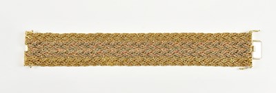 Lot 392 - An 18ct gold three colour broad bracelet,...