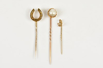 Lot 386 - Three 9ct yellow gold stick pins, combined...