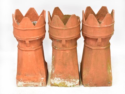 Lot 74 - Three terracotta castle-topped chimney pots,...