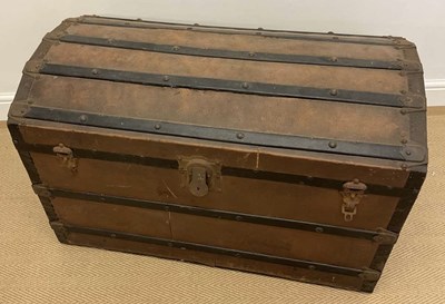 Lot 546 - A domed top wooden and metal travelling trunk,...