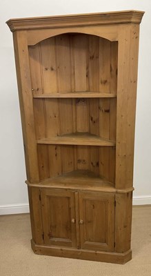 Lot 579 - A pine corner cupboard, with two shelves over...
