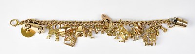 Lot 1136 - A 9ct yellow gold charm bracelet set with...