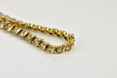 Lot 445 - A 9ct yellow gold line bracelet set with cubic...
