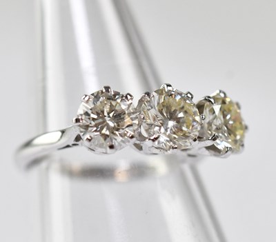 Lot 1070 - An 18ct white gold ring with three claw set...
