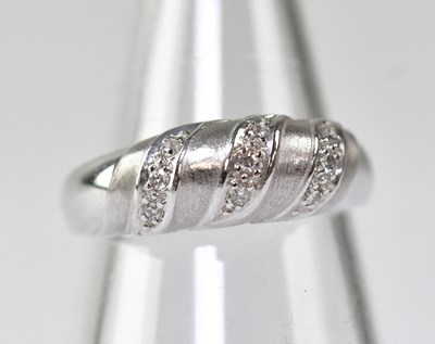Lot 1132 - A white metal and diamond contemporary ring,...