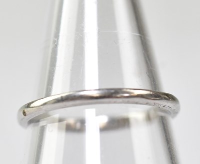 Lot 1057 - A thin platinum band ring, marked 'Platinum'...