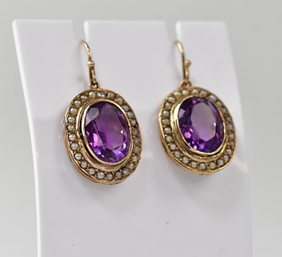 Lot 1230 - A pair of amethyst and seed pearl earrings in...