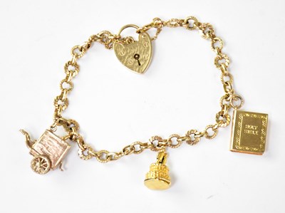 Lot 1137 - A 9ct gold charm bracelet with three charms...