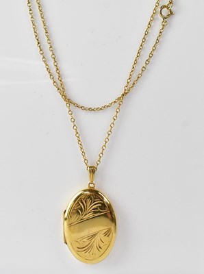 Lot 1190 - A 9ct gold oval double locket with floral...