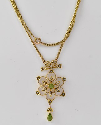 Lot 1194 - A 9ct gold flower design peridot and seed...
