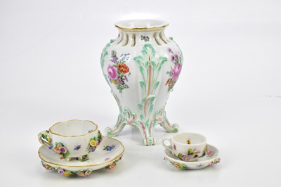 Lot 2869 - MEISSEN; a floral encrusted tea cups and...