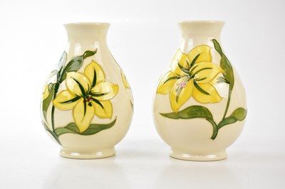 Lot 2768 - MOORCROFT; a pair of baluster shaped vases in...