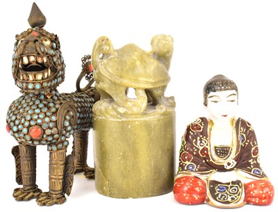 Lot 377 - A Tibetan coral and turquoise mounted gilt metal flask modelled as a temple lion