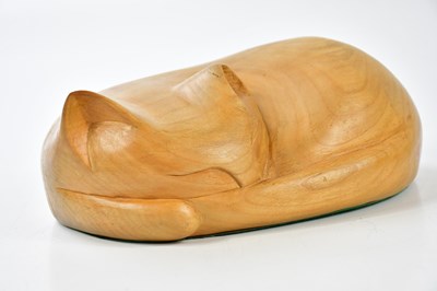 Lot 1538 - TOM LAL (1927-2016); a carved wooden model of a sleeping cat, length 26cm.