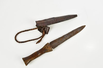 Lot 1390 - An African / Tribal dagger in leather scabbard,...