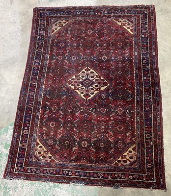 Lot 448 - A Tabriz style dark red ground rug, 210 x 150 cm