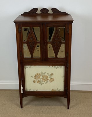 Lot 521 - A mahogany music cabinet, with twin doors with...