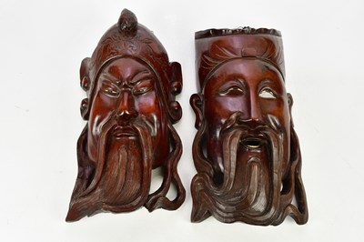Lot 2712 - A pair of Japanese carved wood wall masks...