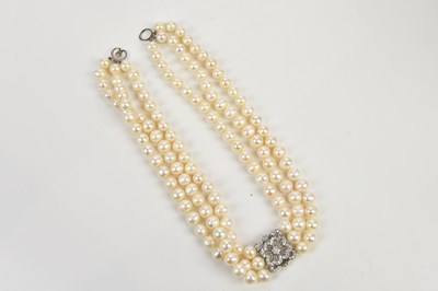 Lot 294 - A three row cultured pearl necklace with...
