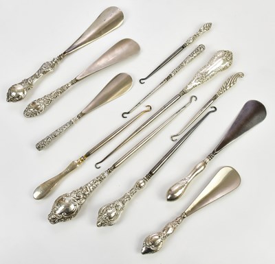 Lot 2414 - Seven hallmarked silver mounted button hooks...