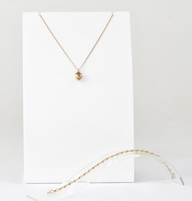 Lot 1207 - A 9ct gold heart pendant on yellow metal chain...