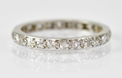 Lot 620 - A white metal eternity ring set with...