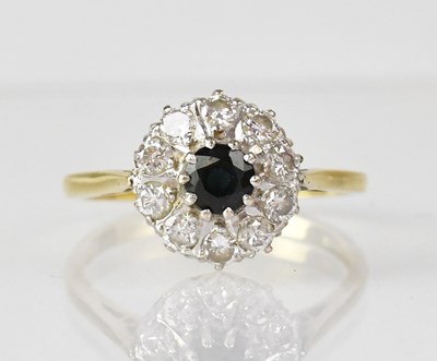Lot 1073 - An 18ct gold ring set with single sapphire...