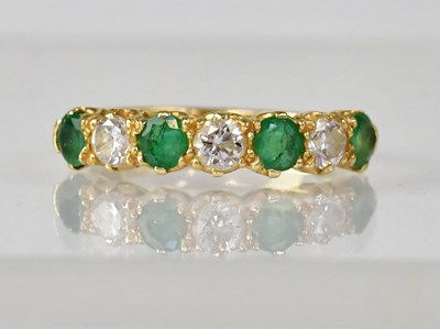 Lot 1087 - An 18ct gold eternity ring set with three...