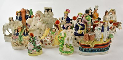 Lot 2844 - A collection of Staffordshire figures...