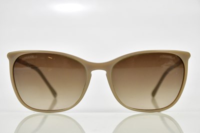 Lot 808 - CHANEL; a pair of beige plastic sunglasses...