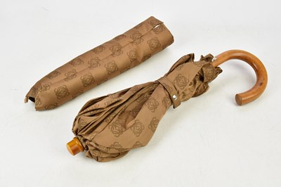 Lot 809 - LOEWE; a large tan cloth umbrella with logo...